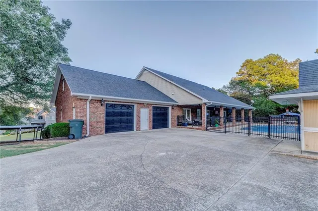 a view of a patio with table and chairs potted plants with wooden floor and fence