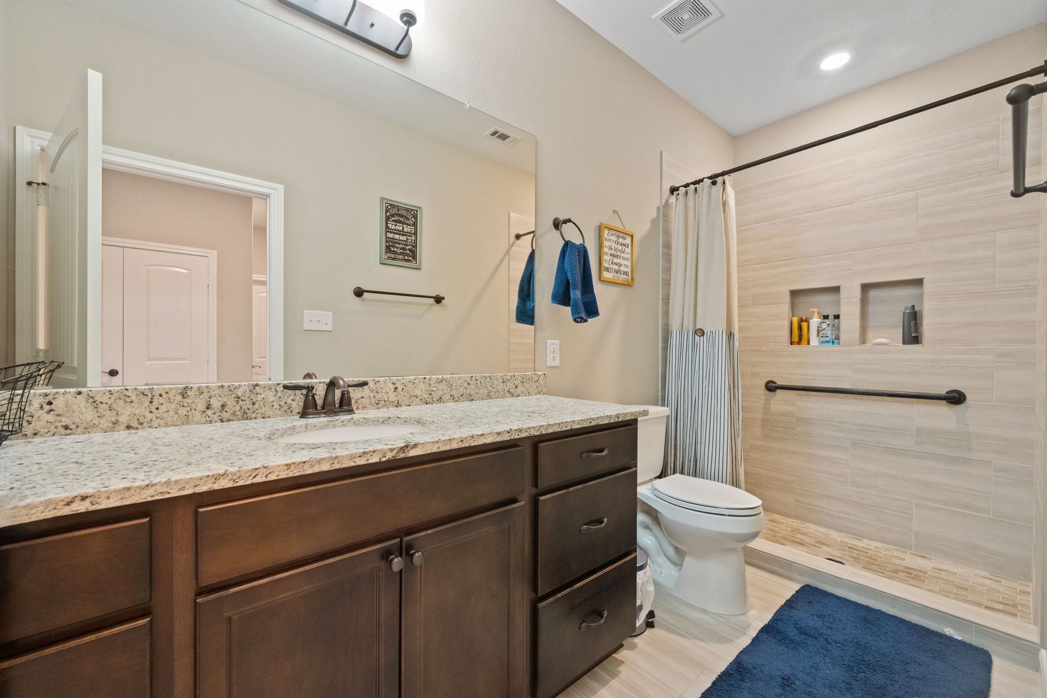 3004 Tyler Street Dayton, TX 77535 - Photo 24 of 34 a bathroom with a granite countertop sink toilet and shower