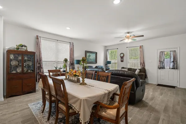 a view of a a dining room with furniture window and wooden floor
