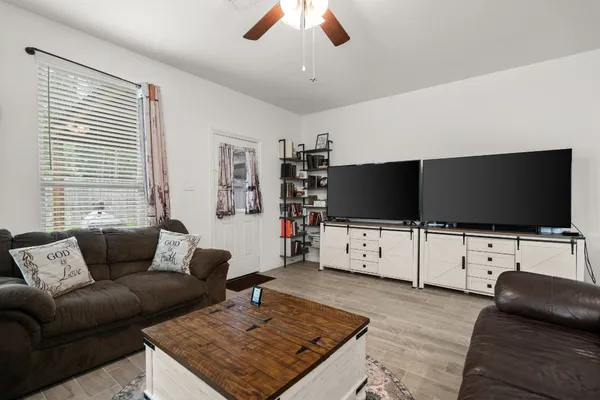 a living room with furniture and a flat screen tv