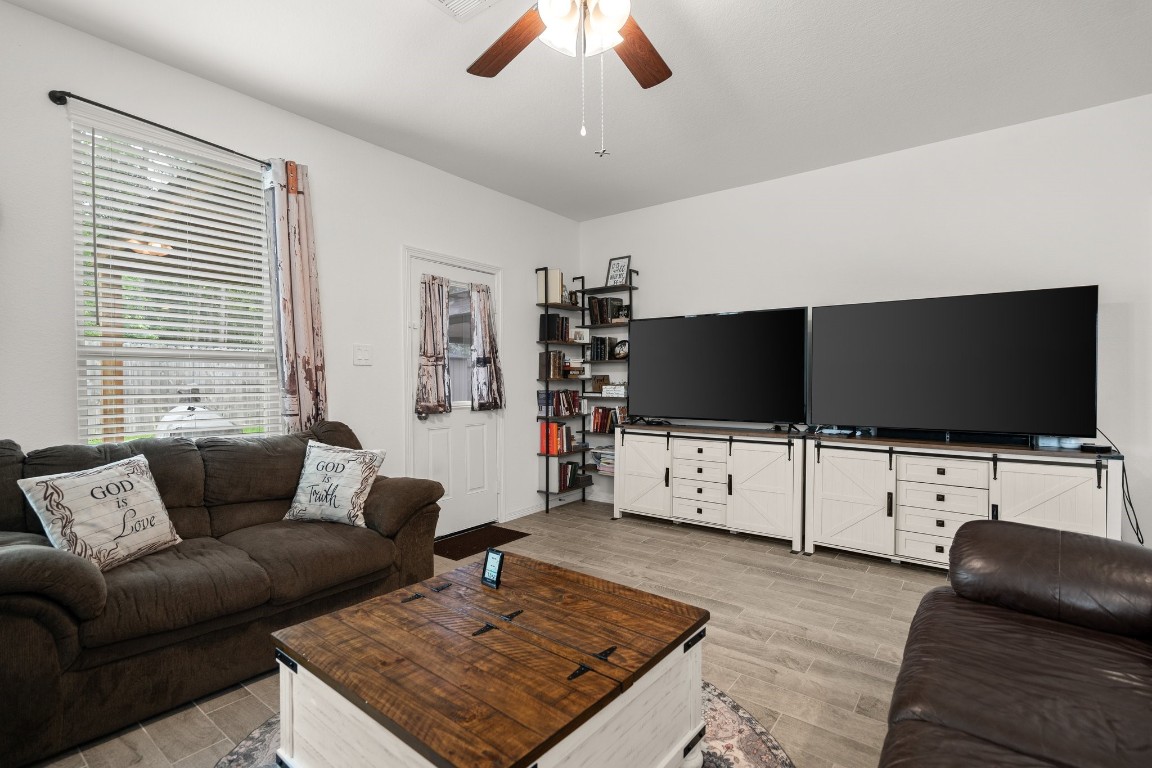 14449 Sunny Bend Way Conroe, TX 77303 - Photo 15 of 34 a living room with furniture and a flat screen tv