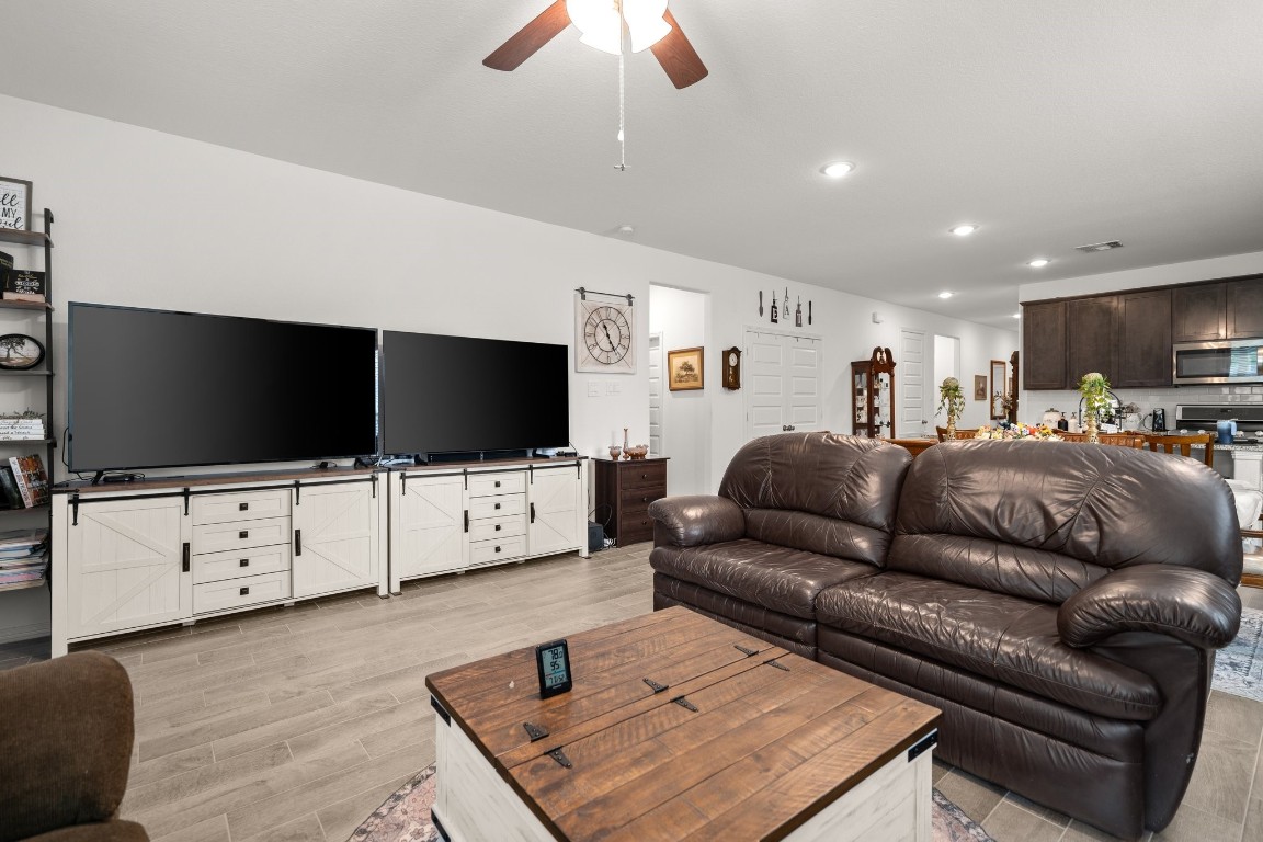 14449 Sunny Bend Way Conroe, TX 77303 - Photo 16 of 34 a living room with furniture and a flat screen tv