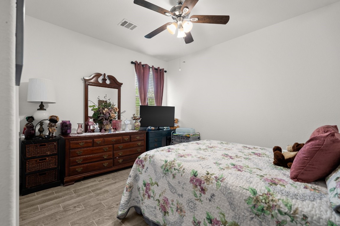 14449 Sunny Bend Way Conroe, TX 77303 - Photo 20 of 34 a bedroom with a bed and a dresser