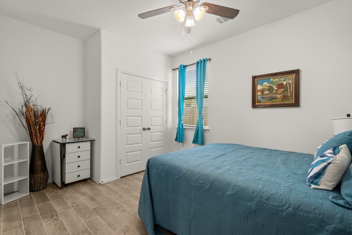 14449 Sunny Bend Way Conroe, TX 77303 - Photo 22 of 34 a spacious bedroom with a bed and a plant