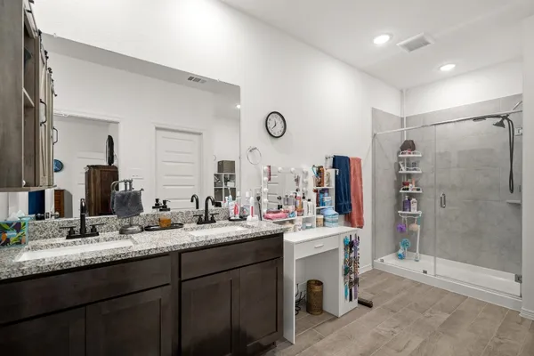 a bathroom with a shower and a bath tub