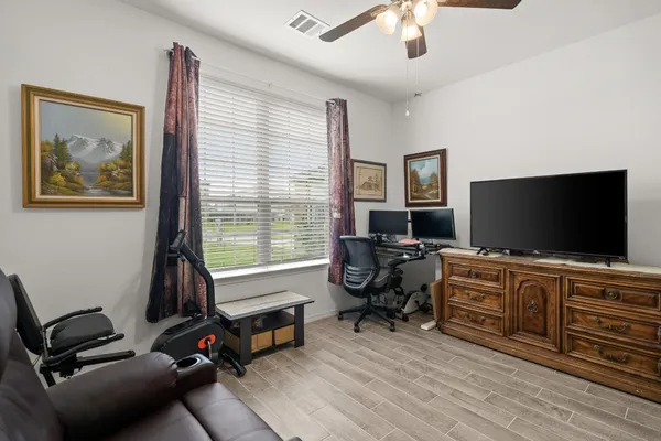 a living room with furniture and cabinets