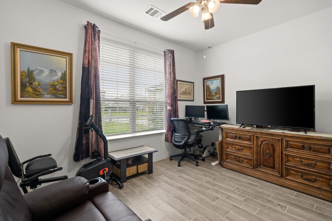 14449 Sunny Bend Way Conroe, TX 77303 - Photo 26 of 34 a living room with furniture and a flat screen tv