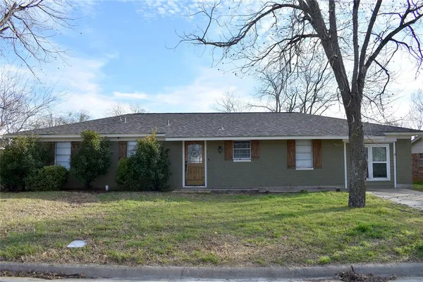 a front view of house with yard and trees