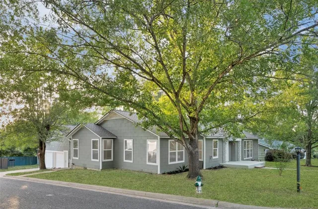 a front view of a house with a garden