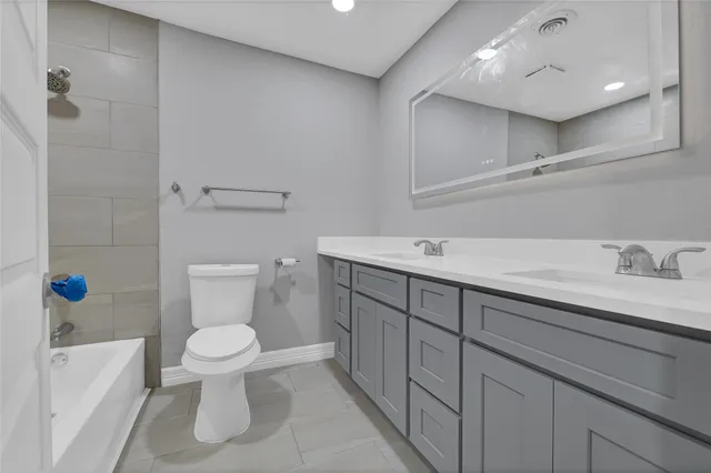 a spacious bathroom with a sink a toilet and shower