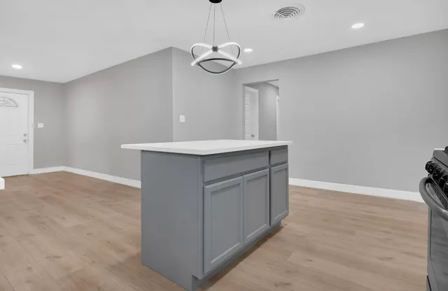 a view of a kitchen with a sink and a chandelier