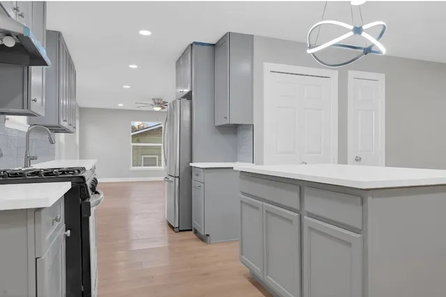 a kitchen with cabinets and a stove