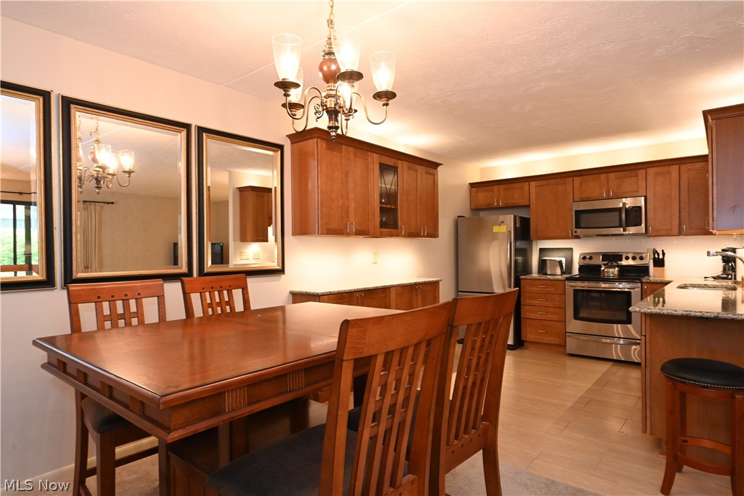 22962 Maple Ridge Road, Unit 108 North Olmsted, OH 44070 - Photo 12 of 37 Dining area with sink and an inviting chandelier