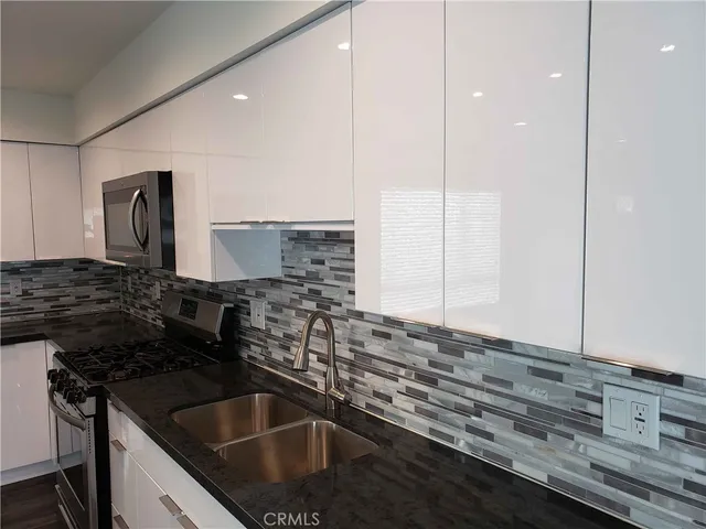 a kitchen that has a sink and a stove