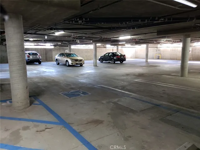 a view of parking garage with cars