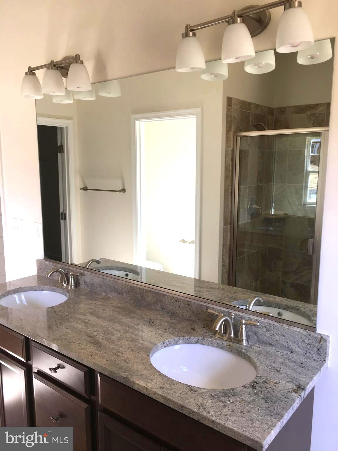 57 Chapel View Lusby, MD 20657 - Photo 3 of 5 a bathroom with a granite countertop sink and a mirror