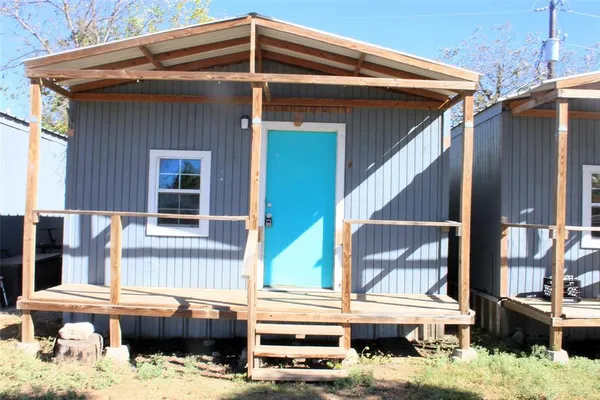 a side view of a house with yard and sitting area