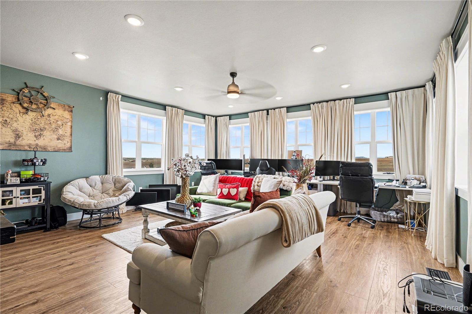 1065 Rising Sun Avenue Elizabeth, CO 80107 - Photo 14 of 37 a living room with furniture or window and a wooden floor