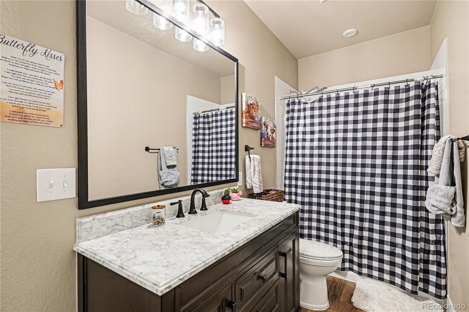 1065 Rising Sun Avenue Elizabeth, CO 80107 - Photo 18 of 37 a bathroom with a sink toilet and shower