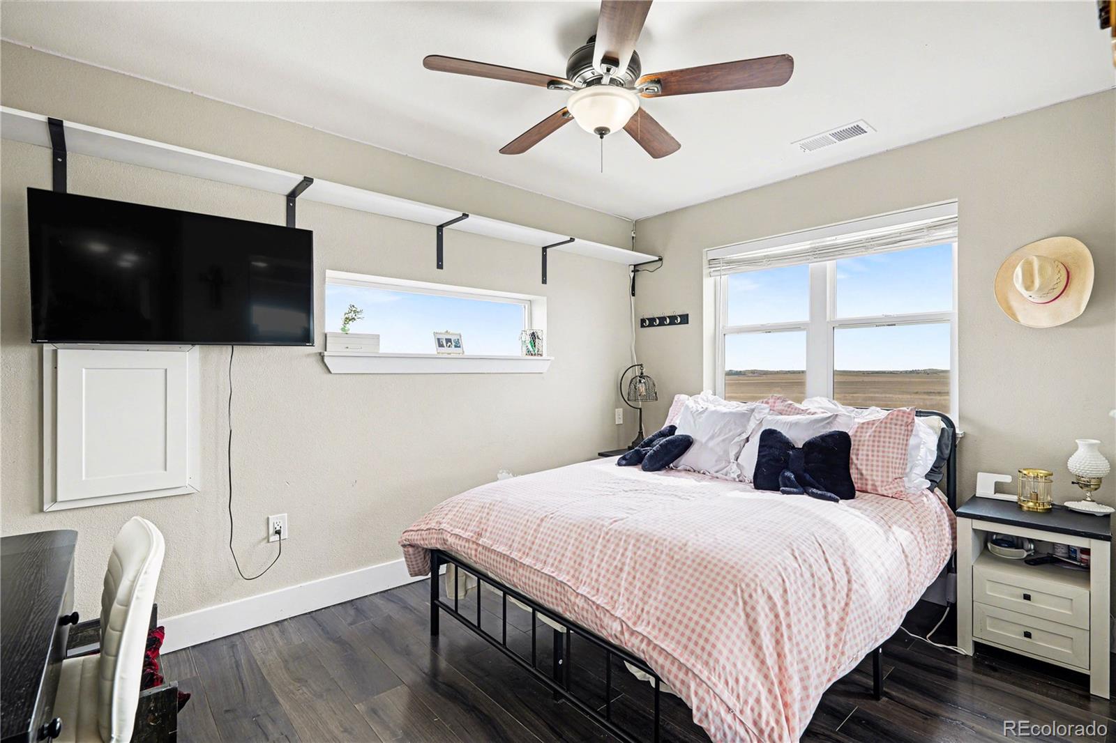 1065 Rising Sun Avenue Elizabeth, CO 80107 - Photo 26 of 37 a bedroom with a bed a flat screen tv and a window