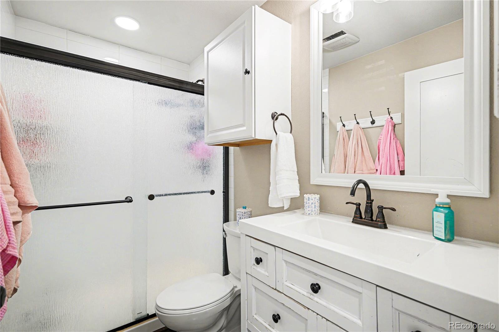 1065 Rising Sun Avenue Elizabeth, CO 80107 - Photo 27 of 37 a bathroom with a sink a toilet and a mirror