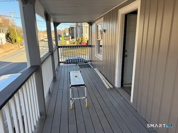 a view of a balcony with wooden floor