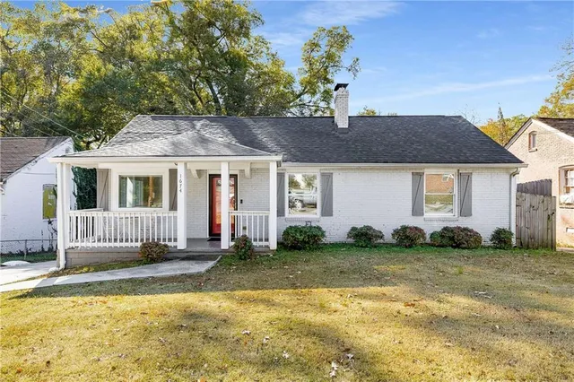 a house that has a big yard plants and large trees