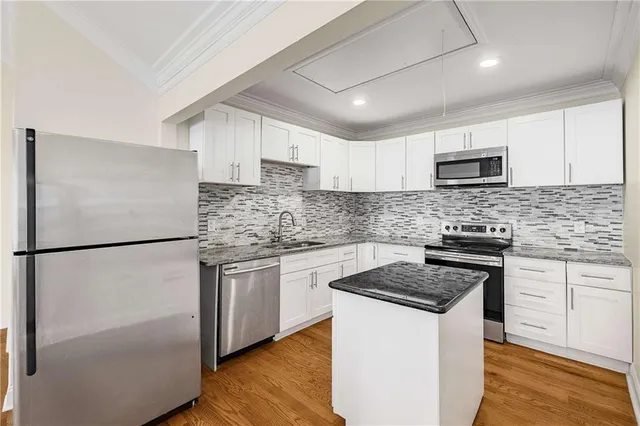 a kitchen with a refrigerator stove and microwave