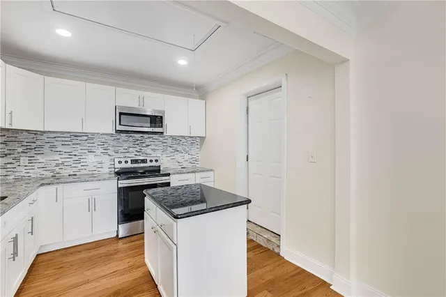 a kitchen with a sink and a stove top oven