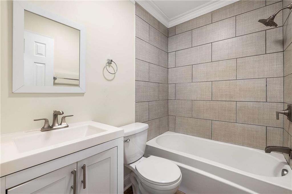 1674 Browning Street Southwest Atlanta, GA 30314 - Photo 14 of 35 a bathroom with a sink a toilet and bathtub