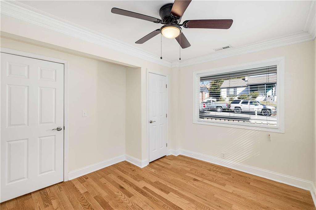 1674 Browning Street Southwest Atlanta, GA 30314 - Photo 20 of 35 a view of an empty room with window and wooden floor