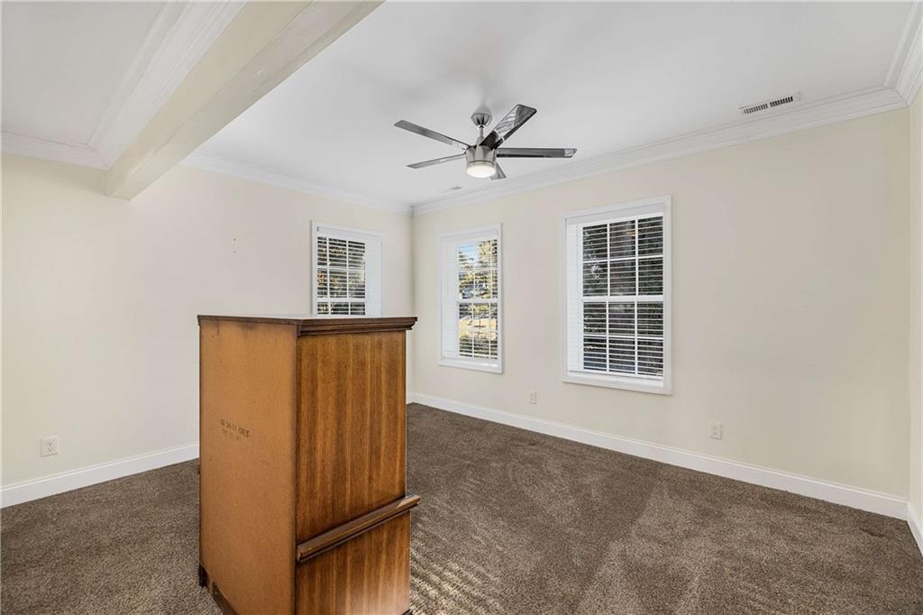 1674 Browning Street Southwest Atlanta, GA 30314 - Photo 27 of 35 a view of a livingroom with wooden floor and a ceiling fan
