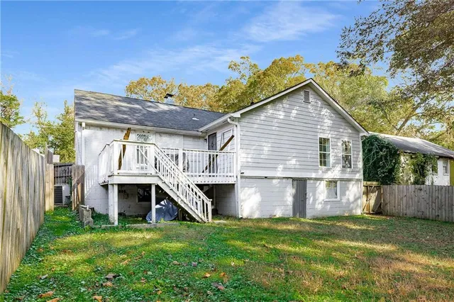 a white house that has a tree in front of it