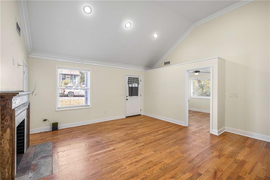 1674 Browning Street Southwest Atlanta, GA 30314 - Photo 6 of 35 wooden floor in an empty room with a fireplace