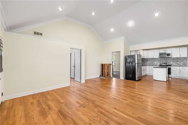 a view of kitchen with refrigerator stove microwave and cabinets