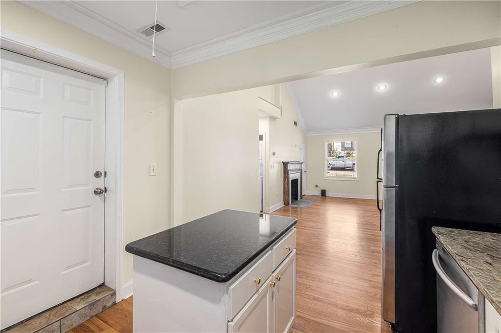 1674 Browning Street Southwest Atlanta, GA 30314 - Photo 10 of 35 a kitchen with a refrigerator a sink and a stove top oven