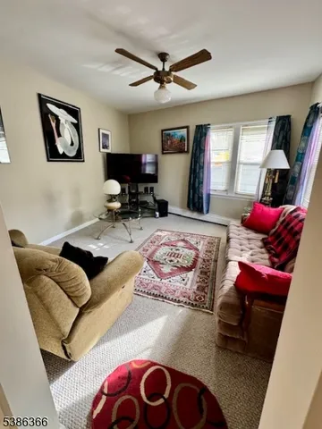 a living room with furniture rug and window
