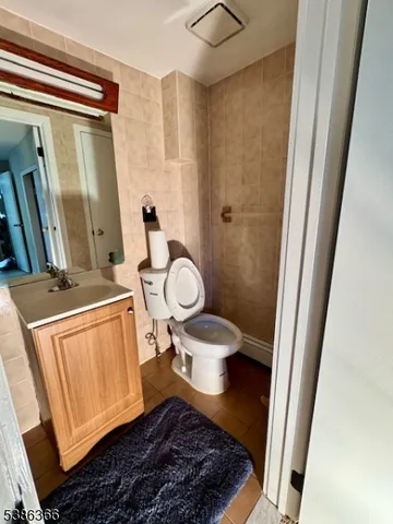 a bathroom with a toilet and a mirror