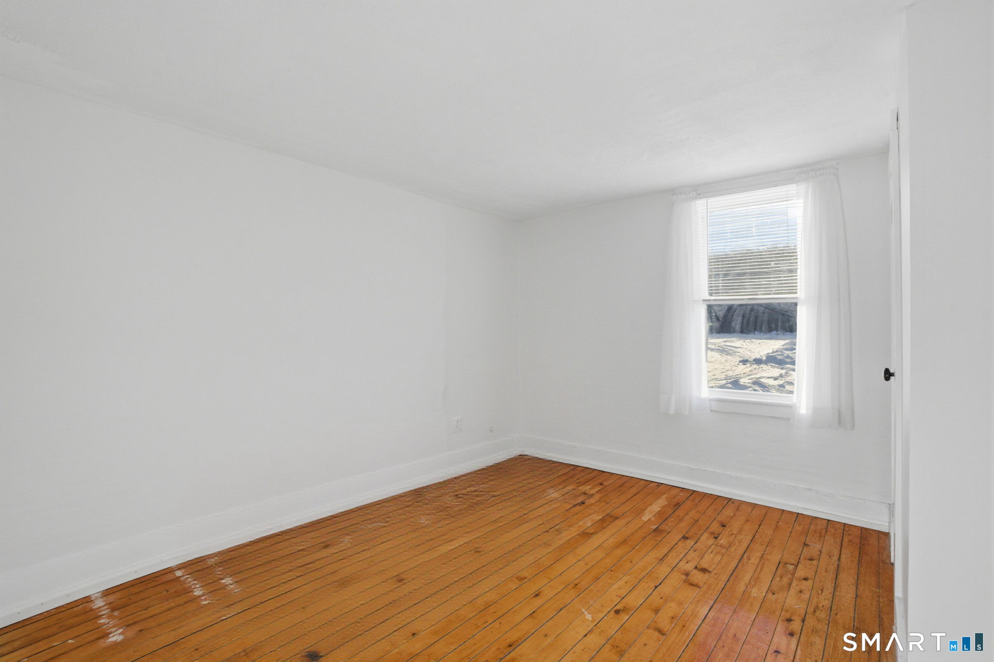 380 North Granby Road Granby, CT 06060 - Photo 13 of 39 a view of an empty room with wooden floor and a window