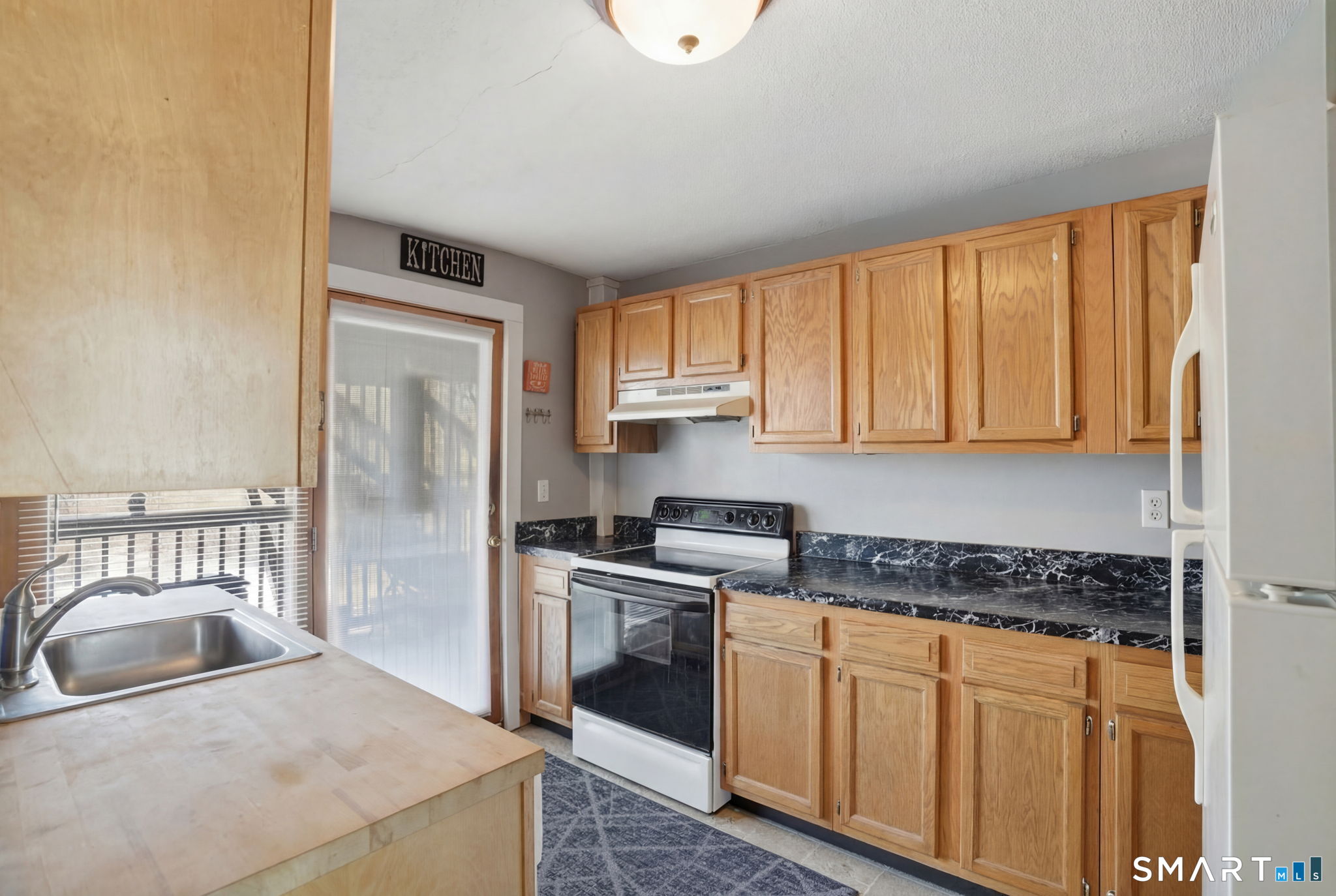 380 North Granby Road Granby, CT 06060 - Photo 19 of 39 a kitchen with stainless steel appliances granite countertop a stove a sink and a refrigerator with cabinets