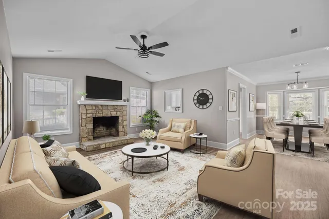 a living room with furniture a fireplace and a flat screen tv