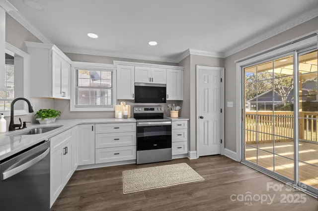 a kitchen with stainless steel appliances a stove sink and cabinets