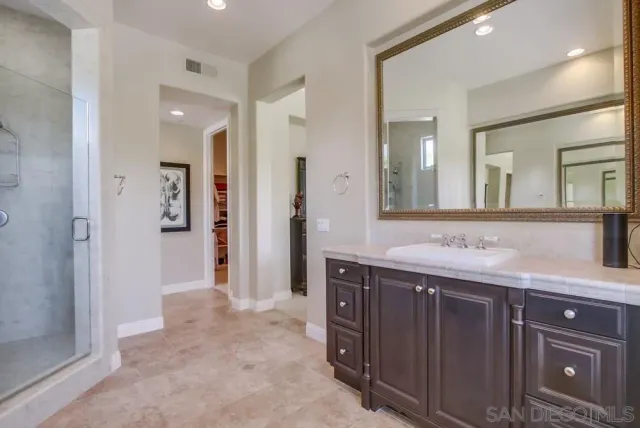 a bathroom with a granite countertop sink mirror and a