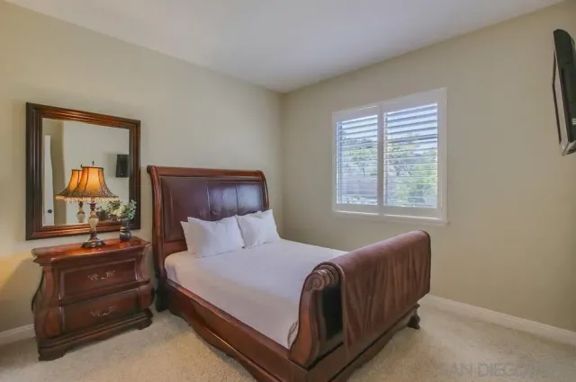 a bedroom with a bed and window