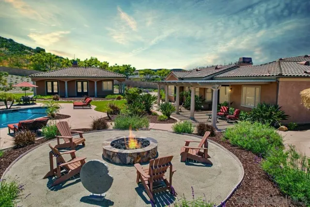 an outdoor space with furniture and garden