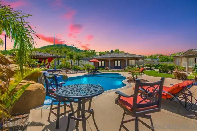 a view of swimming pool with outdoor seating