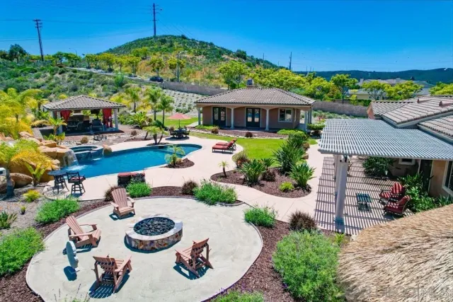 a view of a patio with furniture and a garden