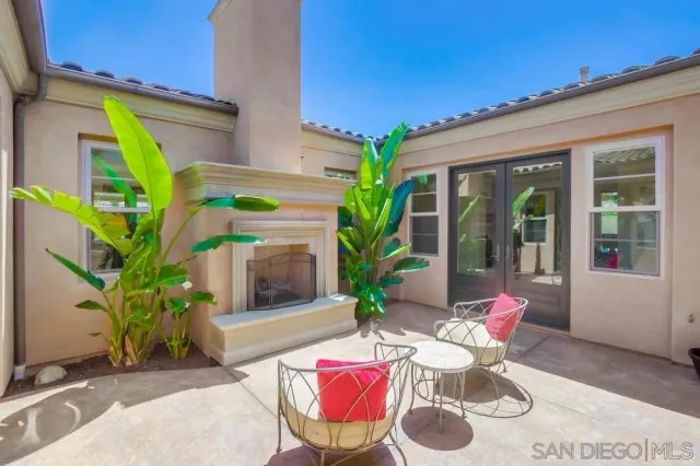 a view of a patio with table and chairs and potted plants