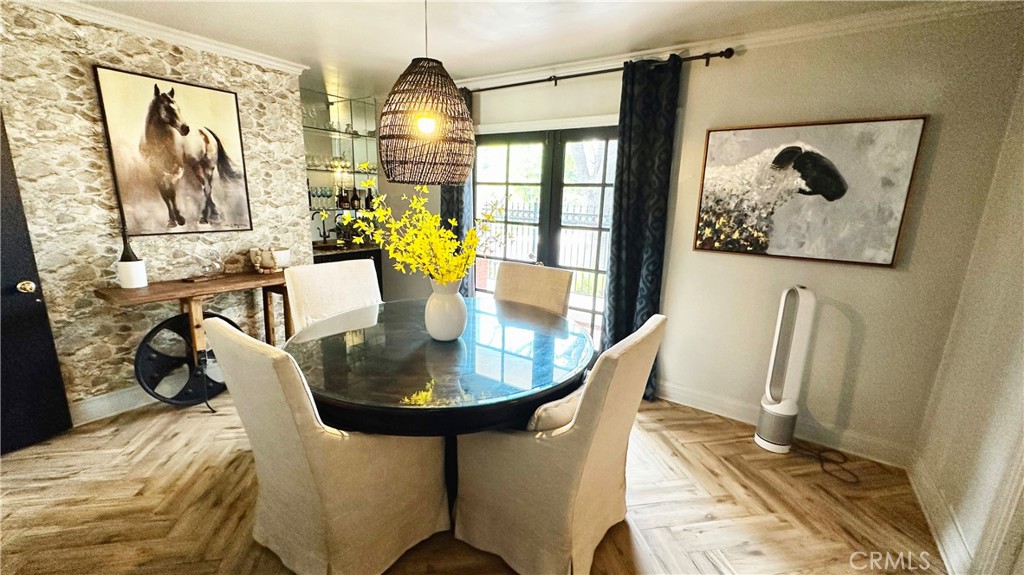 19559 Tulsa Street Porter Ranch, CA 91326 - Photo 12 of 55 a view of a dining room with furniture a rug and wooden floor