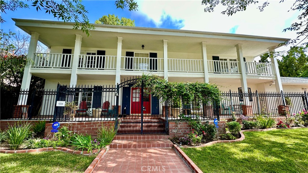 19559 Tulsa Street Porter Ranch, CA 91326 - Photo 2 of 55 a front view of a building with garden